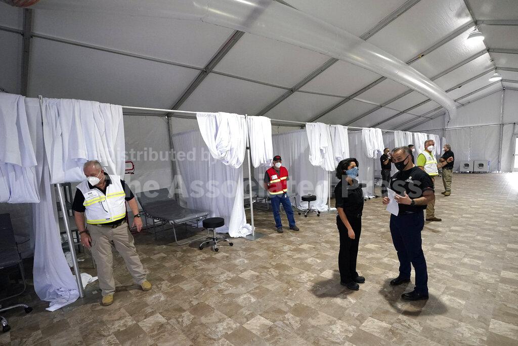 Harris County Public Health Executive Director Dr. Umair A. Shah, right, talks with Harris County Judge Lina Hidalgo during a tour of the new Harris County Non-Congregate Medical Shelter at NRG Park Saturday, April 11, 2020, in Houston. The new temporary setup will have 250 beds initially with a capacity of 2000 beds, if needed, to help relieve pressure on the hospital system from COVID-19 patients. Activation is not intended at this time. (AP Photo/David J. Phillip)