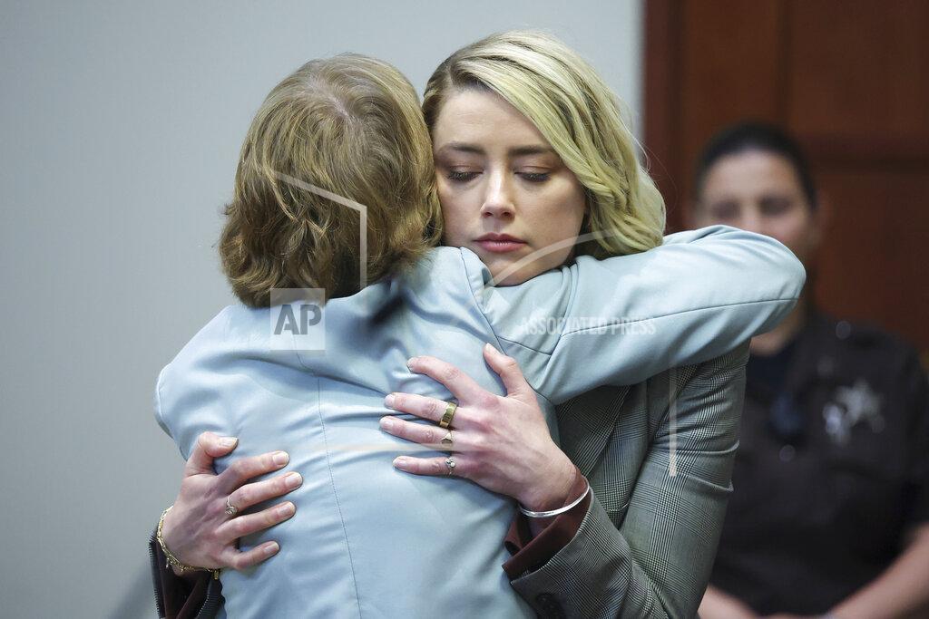 Michael Reynolds Actor Amber Heard hugs her attorney Elaine Bredehoft after she testified in the courtroom in the Fairfax County Circuit Courthouse in Fairfax, Va., Thursday, May 26, 2022. Actor Johnny Depp sued his ex-wife Amber Heard for libel in Fairfax County Circuit Court after she wrote an op-ed piece in The Washington Post in 2018 referring to herself as a "public figure representing domestic abuse." (Michael Reynolds/Pool Photo via AP)