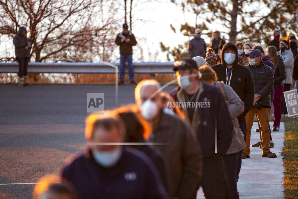 Alex Kormann A long line of voters forms outside of First United Methodist Church as the sun rose over Lake Superior in Duluth, Minn., on Election Day, Tuesday, Nov. 3, 2020. (Alex Kormann/Star Tribune via AP)