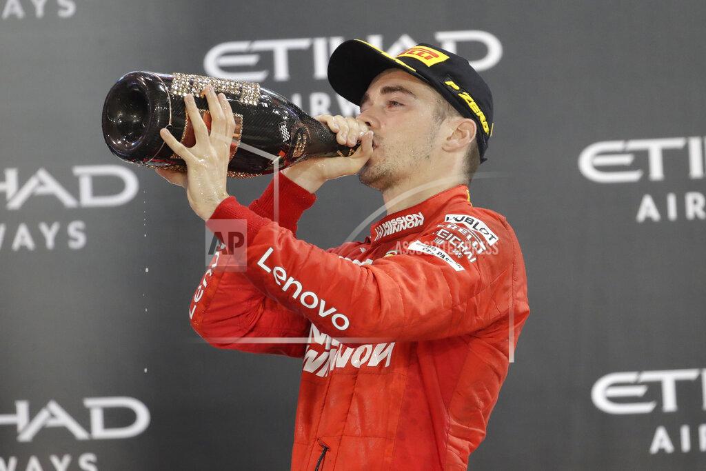 Luca Bruno Third place Ferrari driver Charles Leclerc of Monaco celebrates on the podium after the Emirates Formula One Grand Prix at the Yas Marina racetrack in Abu Dhabi, United Arab Emirates, Sunday, Dec.1, 2019. (AP Photo/Luca Bruno)