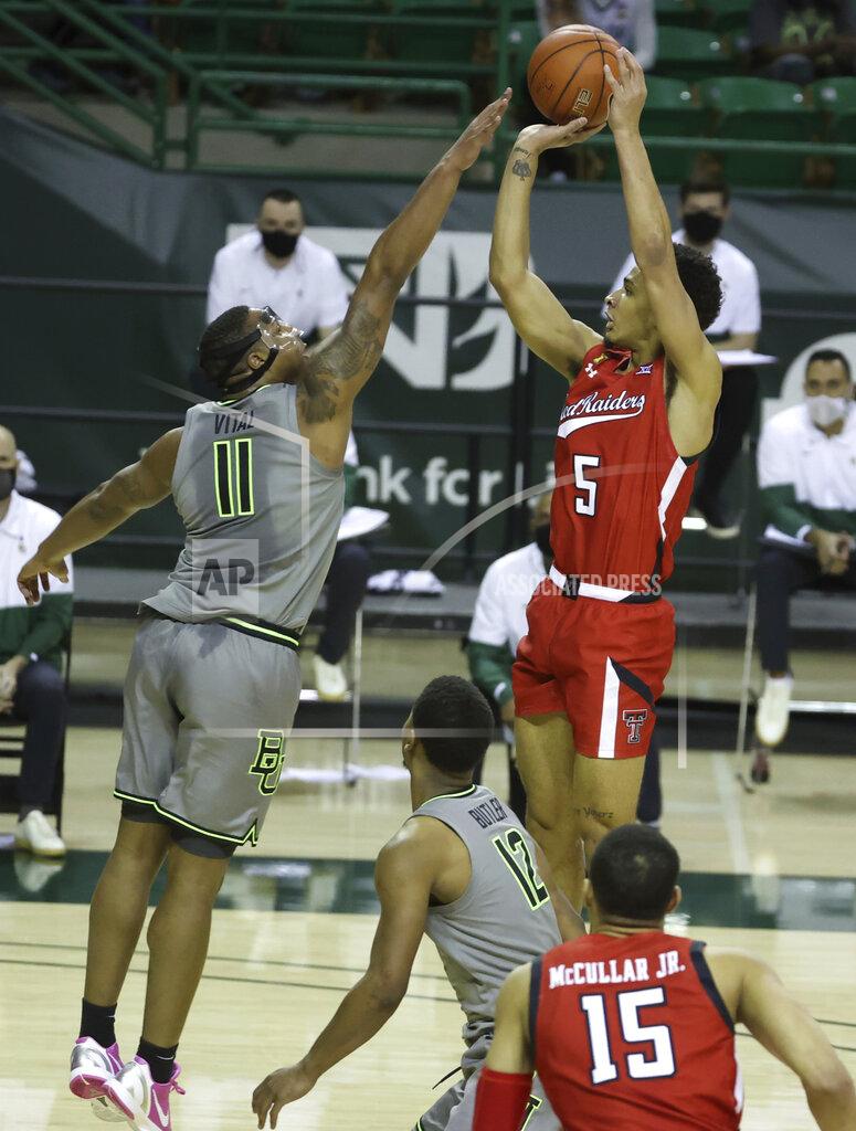 Jerry Larson Texas Tech guard Micah Peavy (5) attempts a shot over Baylor guard Mark Vital (11) in the first half of an NCAA college basketball game Sunday, March 7, 2021, in Waco, Texas. (AP Photo/Jerry Larson)