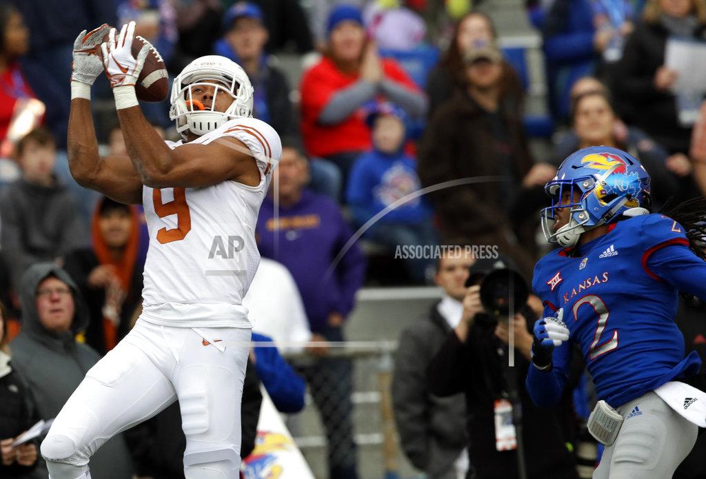 Orlin Wagner Texas wide receiver Collin Johnson (9) catches a Sam Ehlinger pass for a touchdown in front of Kansas cornerback Corione Harris (2) during the first half of an NCAA college football game in Lawrence, Kan., Friday, Nov. 23, 2018. (AP Photo/Orlin Wagner)