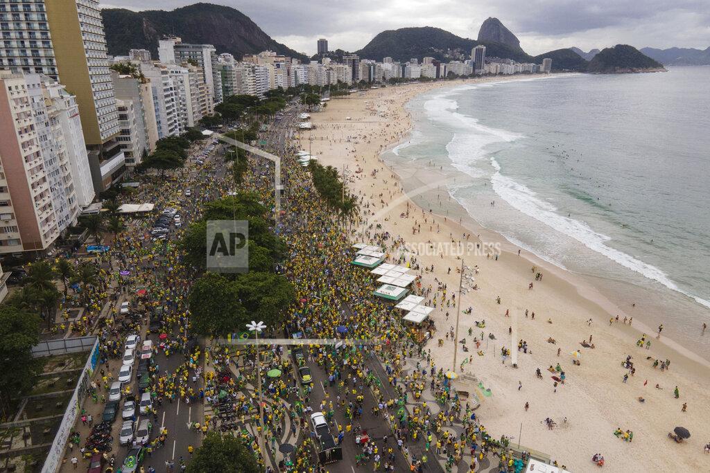 Lucas Dumphreys People gather along Copacabana Beach in a demonstration backing President Jair Bolsonaro’s anti-coronavirus-lockdown stance, marking May Day, or International Workers' Day, in Rio de Janeiro, Brazil, Saturday, May 1, 2021. Brazil has seen over 400,000 confirmed COVID-19 deaths, a toll second only to the United States. (AP Photo/Lucas Dumphreys)