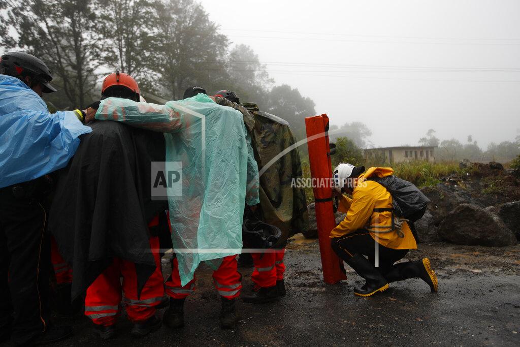 Moises Castillo Volunteer firefighters huddle in prayer before beginning a search and rescue operation in San Cristobal Verapaz, Saturday, Nov. 7, 2020, in the aftermath of Hurricane Eta. Searchers in Guatemala were digging through mud and debris looking for an estimated 100 people believed buried by a massive, rain-fueled landslide, as Eta regained tropical storm strength and churned toward Cuba. (AP Photo/Moises Castillo)