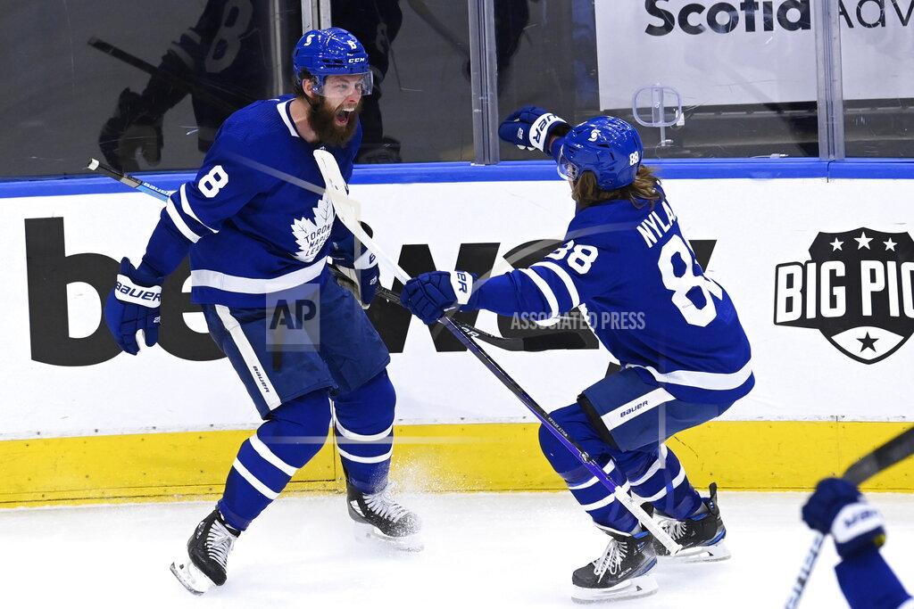 Frank Gunn Toronto Maple Leafs defenseman Jake Muzzin (8) celebrates his goal against the Montreal Canadiens with William Nylander (88) during the third period in Game 5 of an NHL hockey Stanley Cup first-round playoff series in Toronto on Thursday, May 27, 2021. (Frank Gunn/The Canadian Press via AP)