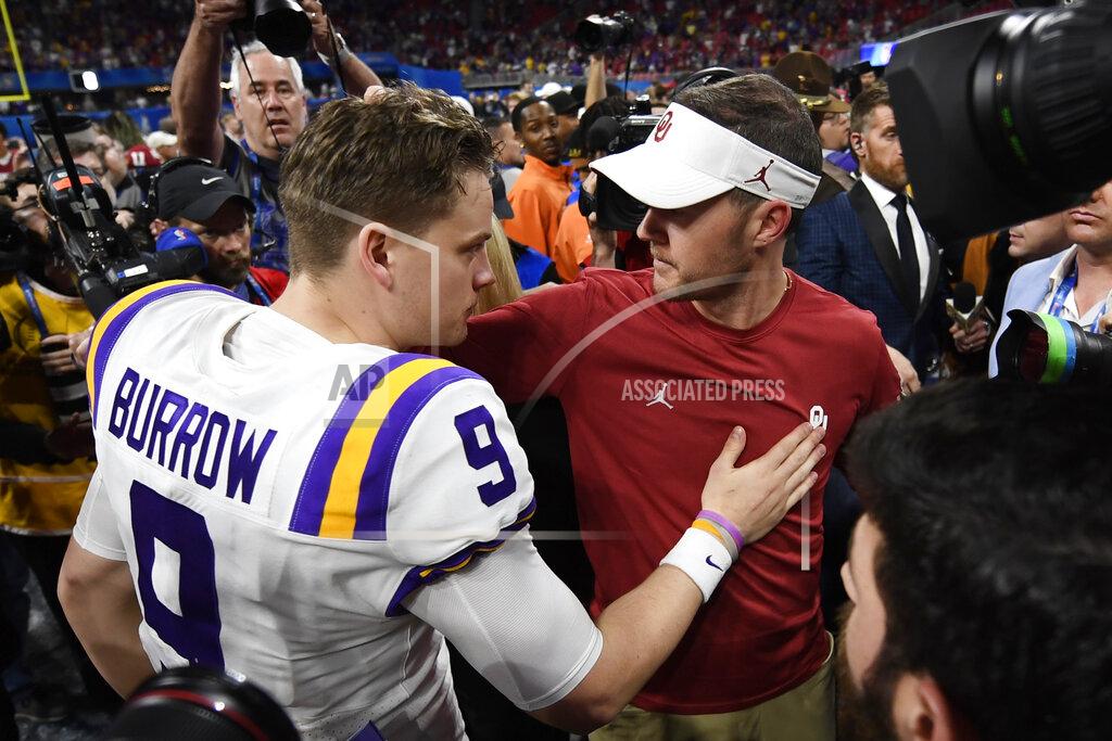 Danny Karnik LSU quarterback Joe Burrow (9) speaks with Oklahoma head coach Lincoln Riley after the Peach Bowl NCAA semifinal college football playoff game, Saturday, Dec. 28, 2019, in Atlanta. LSU won 63-28. (AP Photo/Danny Karnik)