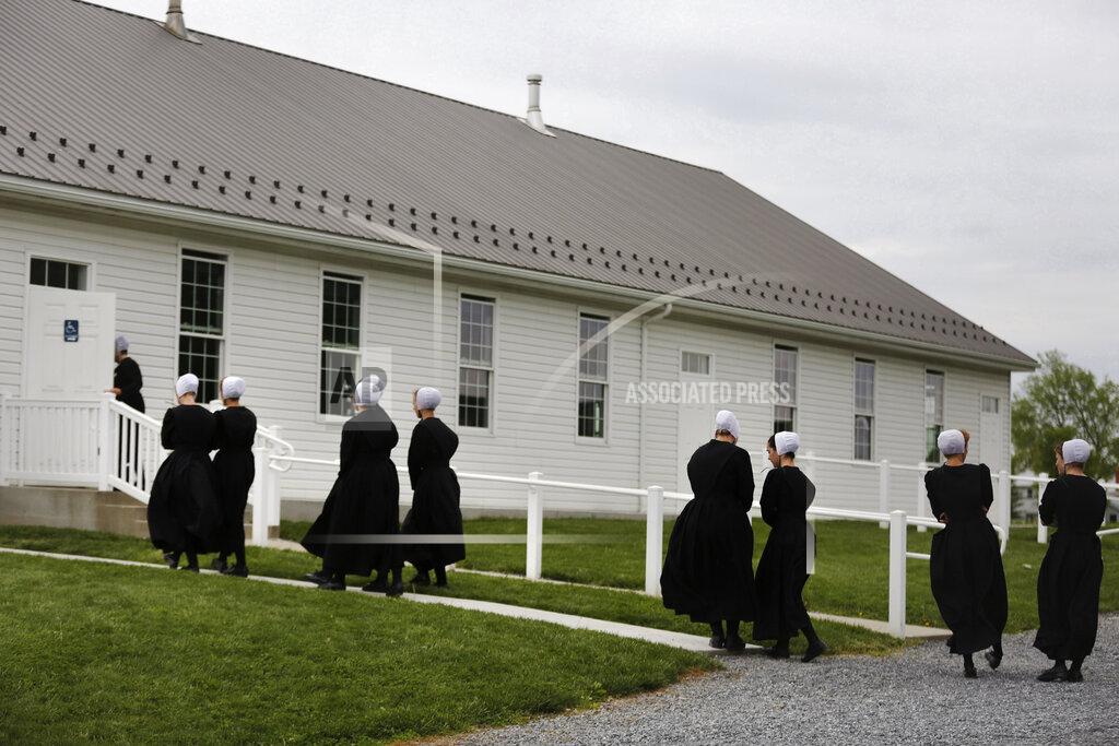 Jessie Wardarski In this Sunday, May 17, 2020, photo, members of the Old Order Stauffer Mennonite Church talk among themselves as they walk into their church for a council meeting with the ministry in New Holland, Pa. Having followed the government's COVID-19 guidelines for nearly two months, the church's more than 200 members gathered for their first in-person service. (AP Photo/Jessie Wardarski)