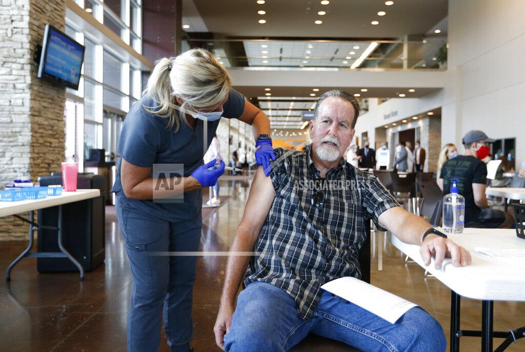 Nathan Papes FILE - In this July 12, 2021 file photo, Dennis Shaffer receives a COVID-19 vaccine shot from Jordan Valley Community Health RN Michelle Butcher at a vaccination clinic hosted by James River Church West Campus in conjunction with Jordan Valley Community Health Center in Springfield, Mo. Across Missouri, hundreds of pastors, priests and other church leaders are reaching out to urge vaccinations in a state under siege from the delta variant. Health experts say the spread is due largely to low vaccination rates — Missouri lags about 10 percentage points behind the national average for people who have initiated shots.(Nathan Papes/The Springfield News-Leader via AP File)