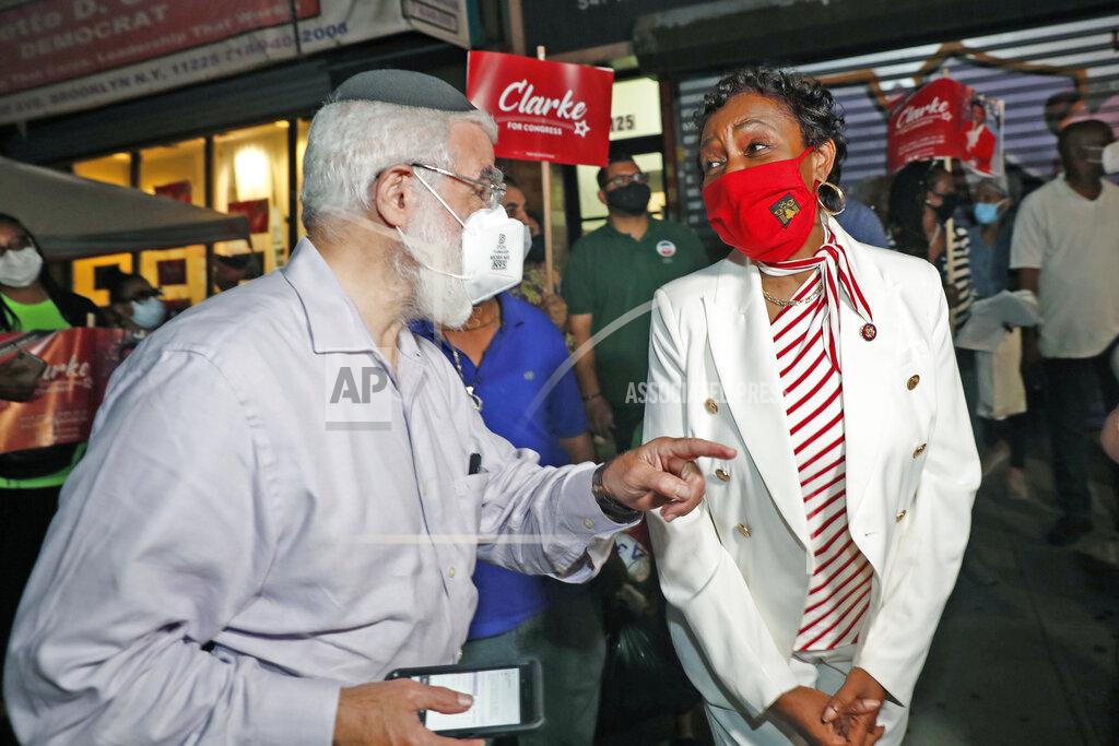 Kathy Willens U.S. Rep. Yvette Clarke, D-N.Y., right, chats with a supporter from her district outside her campaign headquarters, Tuesday, June 23, 2020, in the Brooklyn borough of New York, as New York state primary election results continued to roll in. The longtime Democratic congresswoman faced strong challenges from several candidates in the primary, which had been delayed by the coronavirus outbreak. (AP Photo/Kathy Willens)