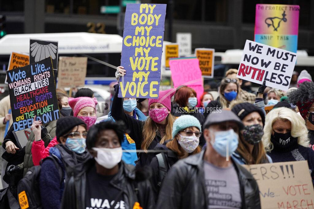 Nam Y. Huh People march during the Women's March in downtown Chicago, Saturday, Oct. 17, 2020. Dozens of Women's March rallies were planned from New York to San Francisco to signal opposition to President Donald Trump and his policies, including the push to fill the seat of late Supreme Court Justice Ruth Bader Ginsburg before Election Day. (AP Photo/Nam Y. Huh)
