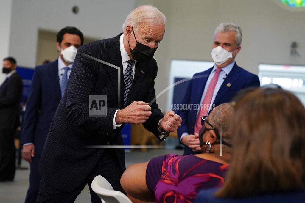President Joe Biden talks to a person receiving a COVID-19 vaccination shot as he visits a vaccination site at Virginia Theological Seminary, Tuesday, April 6, 2021, in Alexandria, Va. (AP Photo/Evan Vucci)