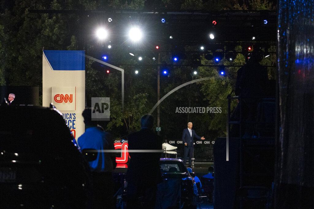 Carolyn Kaster Audience members watch from their cars as Democratic presidential candidate former Vice President Joe Biden speaks during a CNN town hall moderated by Anderson Cooper in Moosic, Pa., Thursday, Sept. 17, 2020. (AP Photo/Carolyn Kaster)