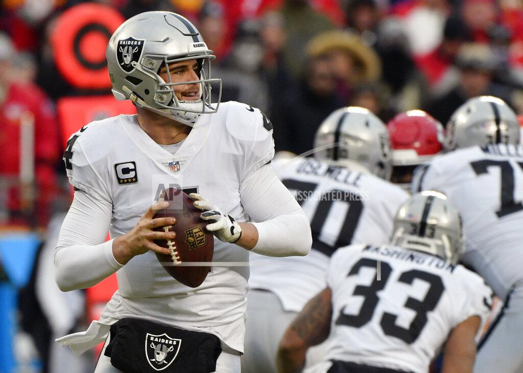Ed Zurga FILE - In this Dec. 30, 2018, file photo, Oakland Raiders quarterback Derek Carr (4) looks for a receiver during the first half of an NFL football game against the Kansas City Chiefs. in Kansas City, Mo. After an offseason filled with rumors about his job status, Carr is back again as starting quarterback for the Raiders. (AP Photo/Ed Zurga, File)