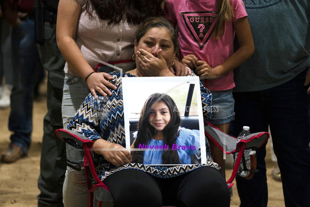 Jae C. Hong Esmeralda Bravo, 63, sheds tears while holding a photo of her granddaughter, Nevaeh, one of the Robb Elementary School shooting victims, during a prayer vigil in Uvalde, Texas, Wednesday, May 25, 2022. (AP Photo/Jae C. Hong)