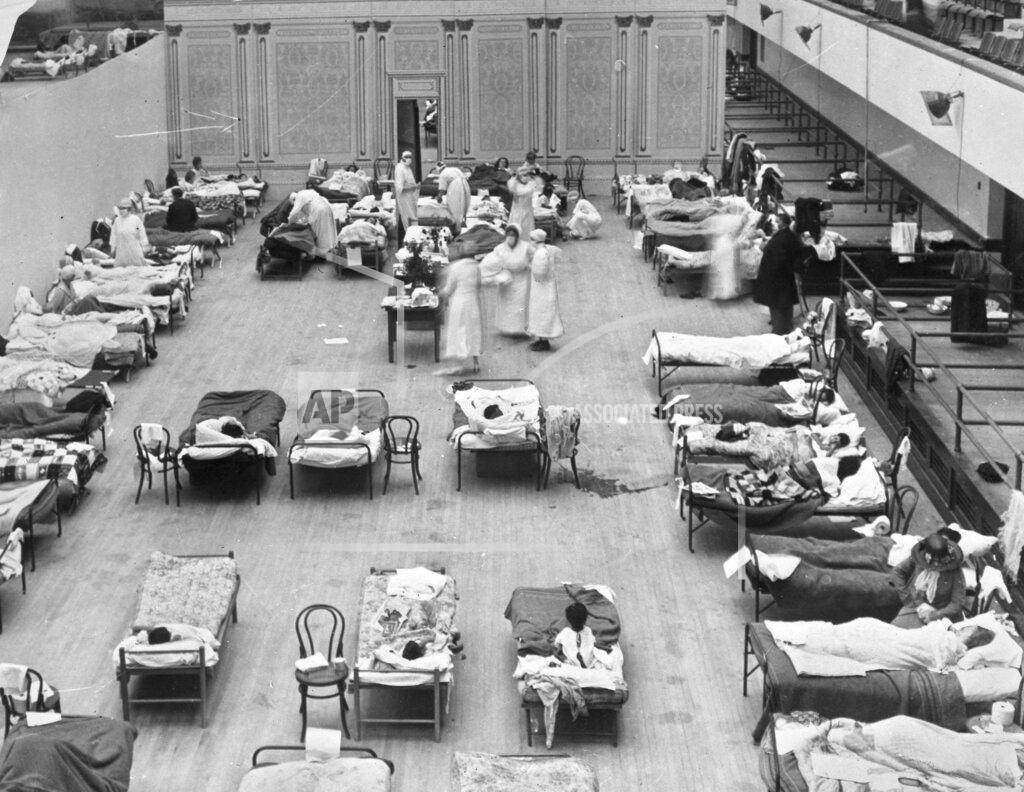 Edward A. "Doc" Rogers FILE - In this 1918 photo made available by the Library of Congress, volunteer nurses from the American Red Cross tend to influenza patients in the Oakland Municipal Auditorium, used as a temporary hospital. (Edward A. "Doc" Rogers/Library of Congress via AP, File)