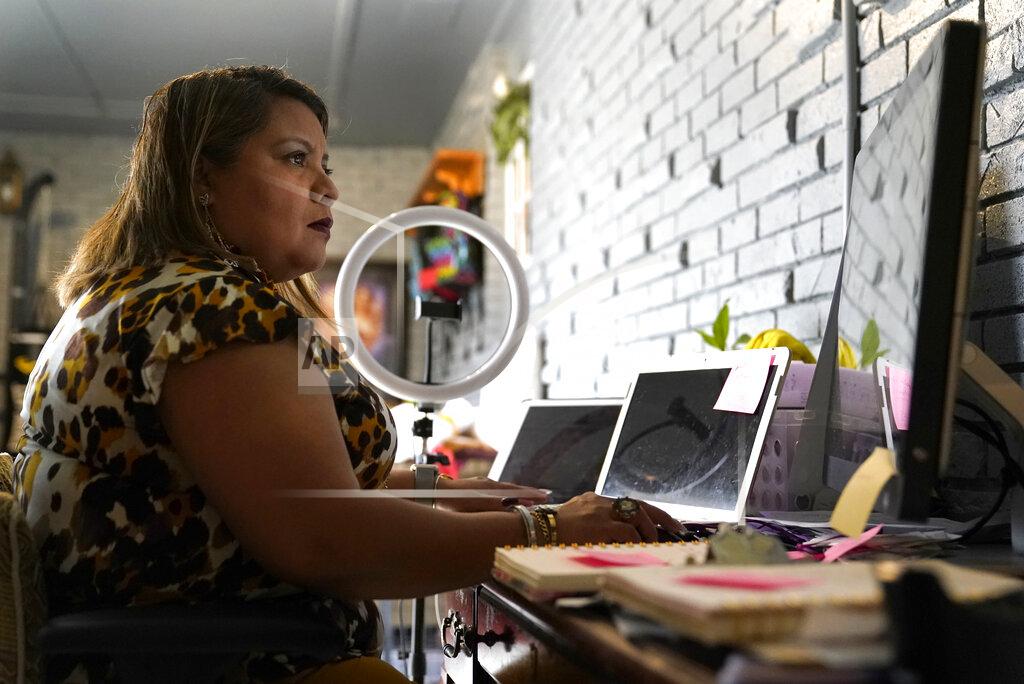 Jeff Roberson Irma Chavez works in her home office, Tuesday, March 9, 2021, in Springdale, Ark. Chavez came to the United States from her home in El Salvador in 1994 when she was 18 and later was granted temporary protected status. (AP Photo/Jeff Roberson)