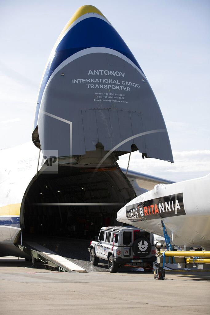 Mark Lloyd This Sept. 28, 2020, photo provided by INEOS Team UK shows the INEOS TEAM UK America's Cup race boat being towed onto an Antonov cargo plane by the teams new prototype INEOS 'Grenadier' 4x4 at the start of its journey to Auckland, New Zealand at London Stansted Airport in England. England's never-ending quest to win back the America's Cup it lost so long ago is taking another step forward with the team's relocation to New Zealand for sailing's marquee regatta. (Mark Lloyd Images/INEOS Team UK via AP)
