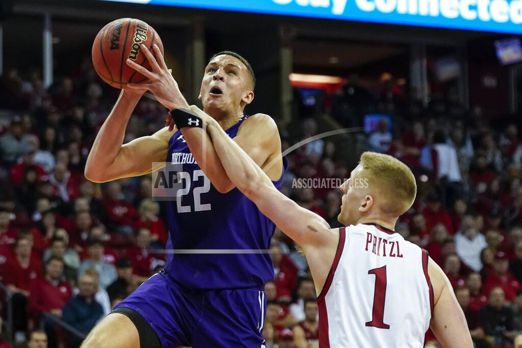 Andy Manis Wisconsin's Brevin Pritzl (1) fouls Northwestern's Pete Nance (22) during the first half of an NCAA college basketball game Wednesday, March 4, 2020, in Madison, Wis. (AP Photo/Andy Manis)