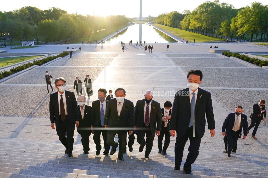 Alex Brandon With the Washington Monument in the background, Japanese Prime Minister Yoshihide Suga visits the Lincoln Memorial, Saturday, April 17, 2021, in Washington. (AP Photo/Alex Brandon)