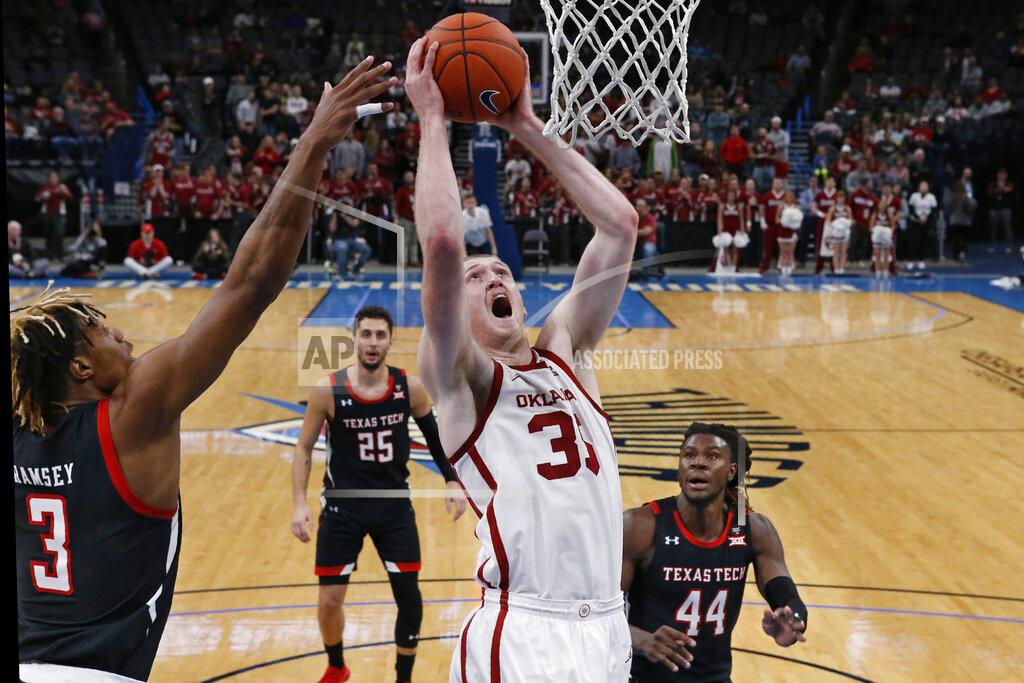 Sue Ogrocki Oklahoma forward Brady Manek (35) shoots between Texas Tech guard Jahmi'us Ramsey (3) and guard Chris Clarke (44) in the second half of an NCAA college basketball game Tuesday, Feb. 25, 2020, in Oklahoma City. (AP Photo/Sue Ogrocki)