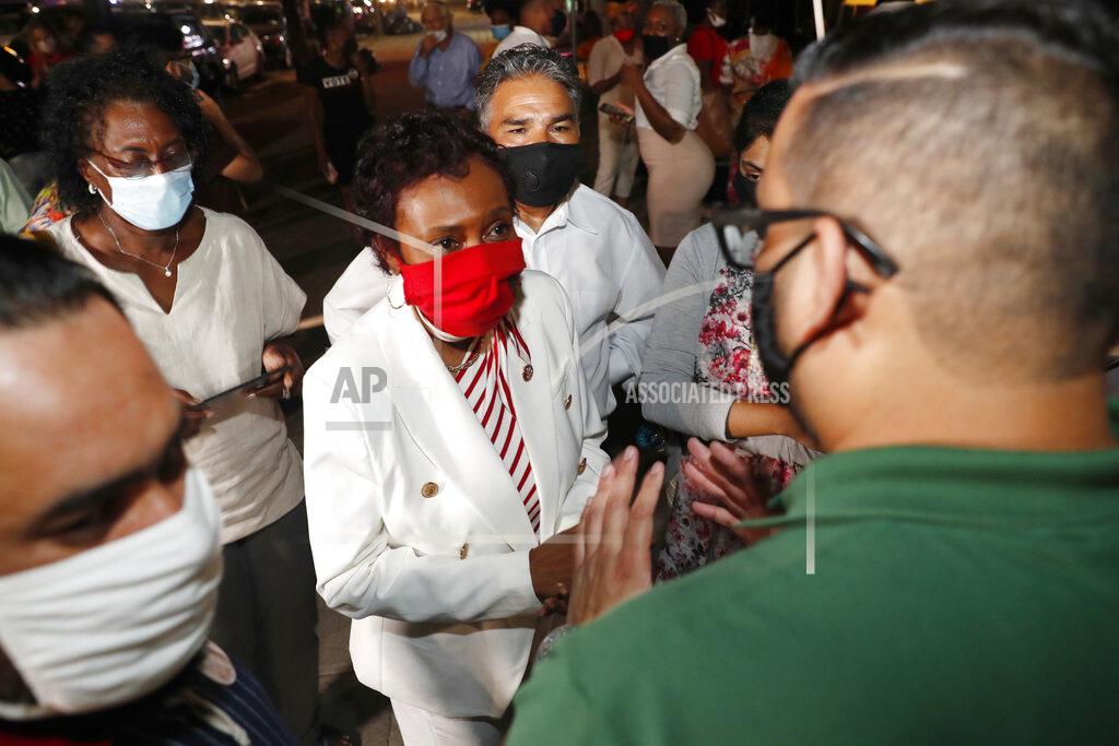 Kathy Willens Muslim supporters surround U.S. Rep. Yvette Clarke, D-N.Y., center, outside Clarke's campaign headquarters, Tuesday, June 23, 2020, in the Brooklyn borough of New York, as results from New York state's primary election continued to be tallied. Clarke, a longtime congresswoman, faced strong challenges from several candidates. (AP Photo/Kathy Willens)