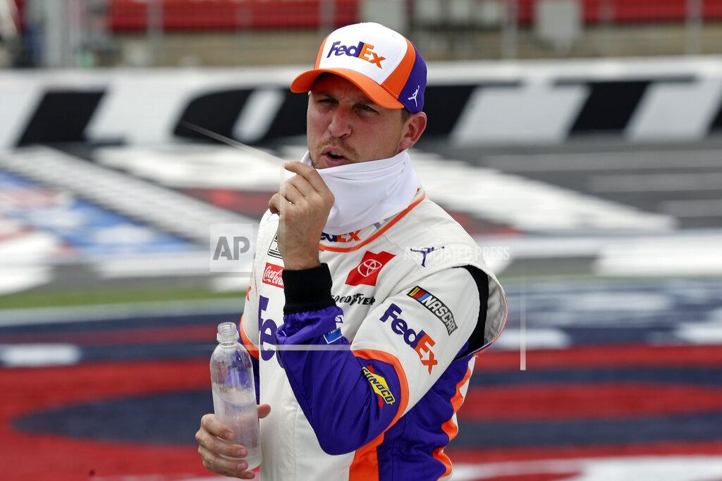 Gerry Broome FILE - In this May 24, 2020, file photo, driver Denny Hamlin waits to qualify prior to the NASCAR Cup Series auto race at Charlotte Motor Speedway in Concord, N.C. Hamlin is 0-for-3 in championship chances, his shot at an elusive first NASCAR crown ending just short of the finish line all three times he’s been close. It’s his turn again, without rival Kevin Harvick in his way in Sunday's season finale at Phoenix Raceway. (AP Photo/Gerry Broome, File)