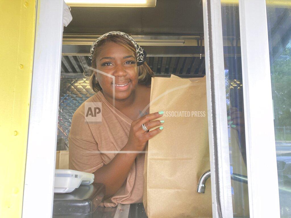 José Ignacio Castañeda Yolanda Parson poses for a picture inside of her food truck, Crab Cravers, at its grand opening in Wilmington, Del., on Sunday, July 18, 2021. (José Ignacio Castañeda /The News Journal via AP)