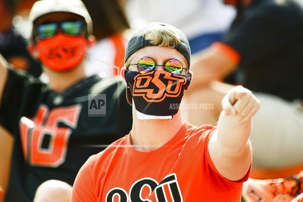 Brody Schmidt A masked Oklahoma State fan reacts during the first half of an NCAA college football game against Tulsa, Saturday, Sept. 19, 2020, in Stillwater, Okla. (AP Photo/Brody Schmidt)