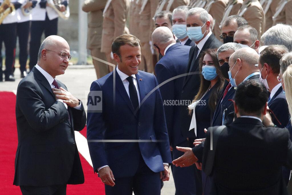 Gonzalo Fuentes Iraqi President Barham Salih welcomes French President Emmanuel Macron, center, at the Salam Palace Wednesday, Sept. 2, 2020 in Baghdad. Macron is the first head of state to visit the Iraqi capital since Prime Minister Mustafa al-Kadhimi, Iraq's former intelligence chief, formed a new government in May. (Gonzalo Fuentes/Pool via AP)