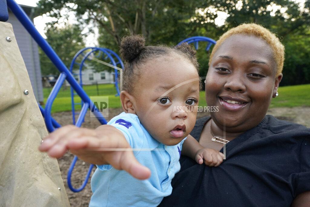 Rogelio V. Solis Brianne Epps of Jackson, Miss., 28, is a single mother with son Nolan Epps, 11 months, photographed Wednesday, July 21, 2021, an older son 4 years old and daughters who are 8 and 6 years old. Epps earns $9 an hour working with infants and toddlers in a childcare center, but she has a bigger dream of operating a soul food catering business. (AP Photo/Rogelio V. Solis)