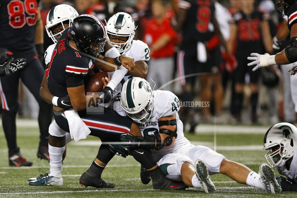 Jay Laprete Ohio State quarterback Justin Fields, front, is sacked by Michigan State defenders Michael Dowell, left, Josiah Scott, center, Kenny Willekes during the first half of an NCAA college football game Saturday, Oct. 5, 2019, in Columbus, Ohio. (AP Photo/Jay LaPrete)