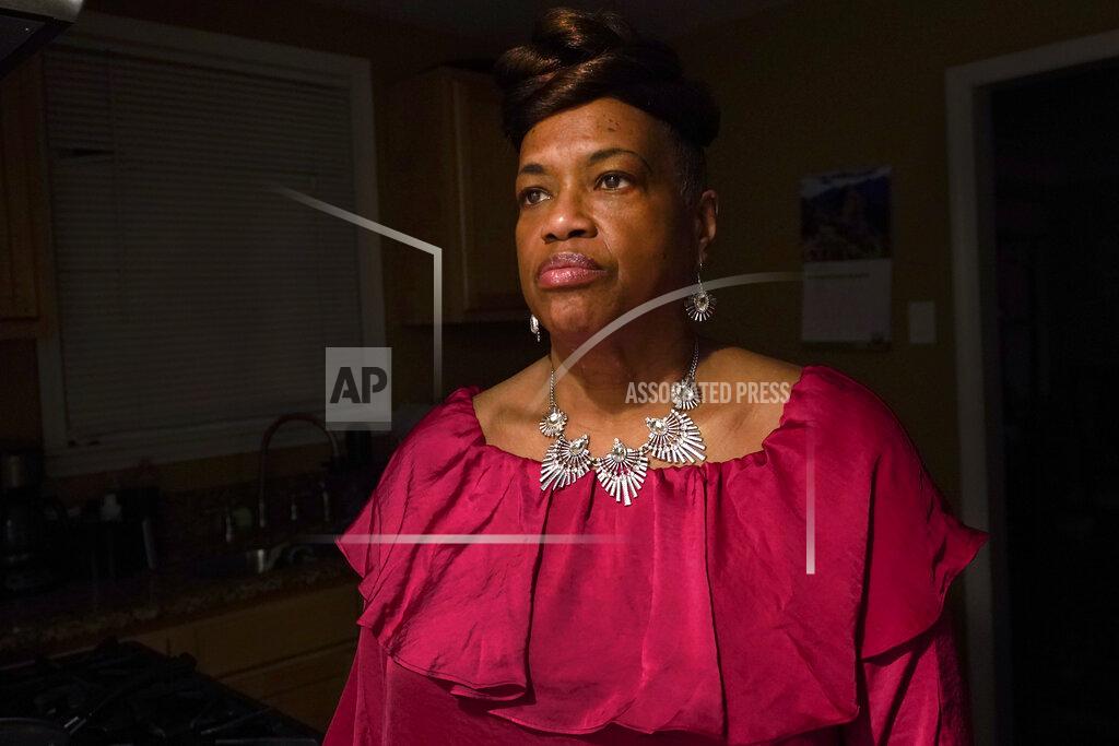 Paul Sancya Karla Jefferies stands in her kitchen in Detroit, Friday, March 5, 2021. Jefferies, 64, a retired state worker in Detroit, Michigan, tested positive for COVID-19 in March 2020 and has been bothered by puzzling symptoms ever since. First it was fatigue, fever, and no taste or smell. Then came brain fog, insomnia, a nagging smell of something burning that only recently disappeared, and intermittent ringing in her ears. Now she can't hear out of her left ear. (AP Photo/Paul Sancya)
