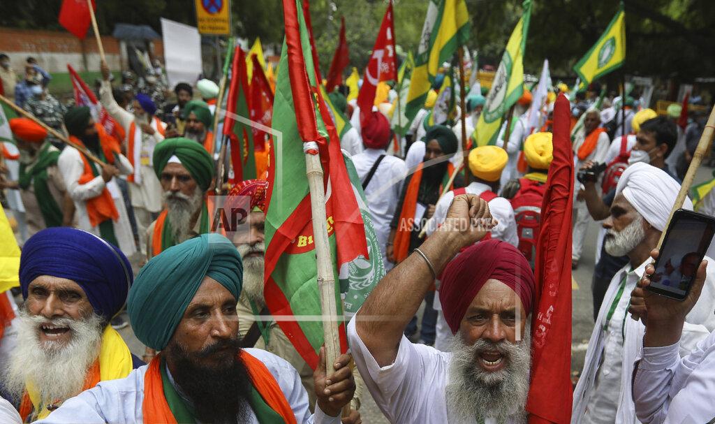Manish Swarup Farmers shout anti government slogans during a protest in New Delhi, India, Thursday, July 22, 2021. More than 200 farmers on Thursday began a protest near India's Parliament to mark eight months of their agitation against new agricultural laws that they say will devastate their income. (AP Photo/Manish Swarup)