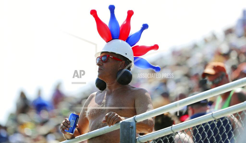 John Munson A fan with a balloon hat watches the NASCAR Cup Series auto race at Watkins Glen International, Sunday, Aug. 4, 2019, in Watkins Glen, N.Y. (AP Photo/John Munson)
