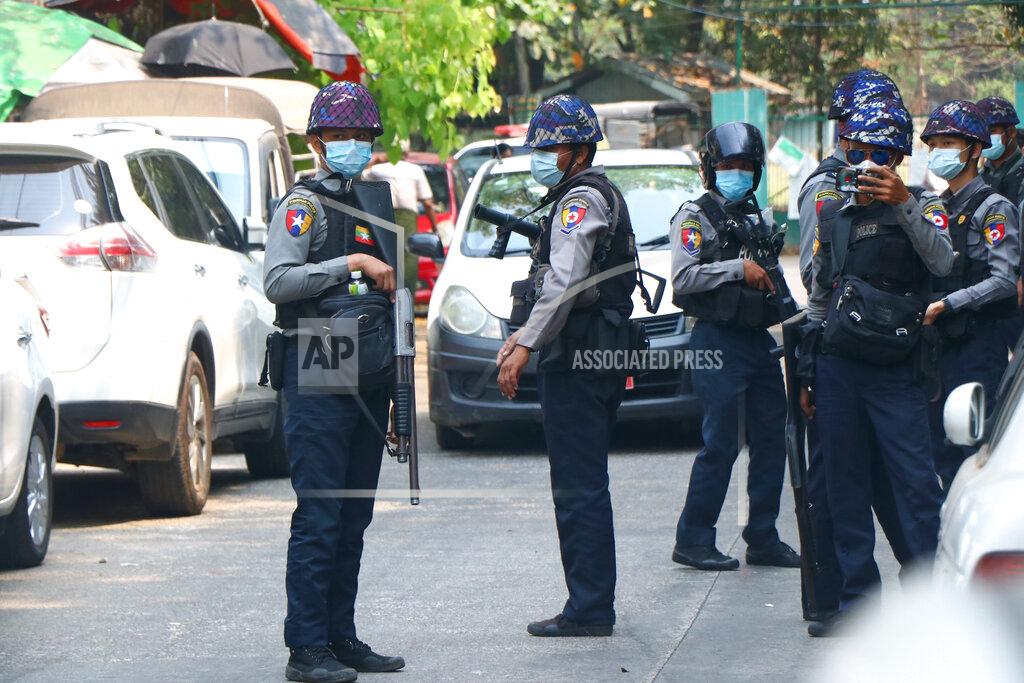 Uncredited Police gather outside the Kamayut court in Yangon, Myanmar Friday, March 12, 2021. A court in Myanmar is scheduled to hold a hearing on Friday for an Associated Press journalist detained while covering demonstrations against the military's seizure of power last month. He is facing a charge that could send him to prison for three years. (AP Photo)