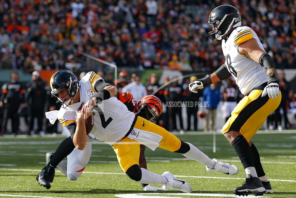 Gary Landers Pittsburgh Steelers quarterback Mason Rudolph (2) grounds the ball under pressure from Cincinnati Bengals defensive end Carl Lawson (58) during the first half an NFL football game, Sunday, Nov. 24, 2019, in Cincinnati. (AP Photo/Gary Landers)