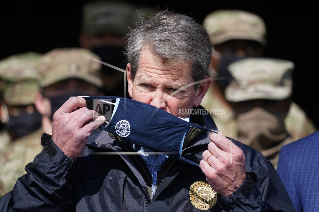 John Bazemore FILE - In this Feb. 19, 2021, file photo, Georgia Gov. Brian Kemp removes his face covering as he prepares to speak to reporters at the Macon State Farmers Market in Atlanta. The COVID-19 relief package passed by Congress contains a windfall for state governments. But some Republican governors are complaining about the formula used to dole out the money. “Instead of using the bipartisan blueprint of previous federal coronavirus relief bills, this legislation is literally a wish list for California and New York,” Kemp said. “And quite honestly, it’s a slap in the face for my fellow Georgians.” (AP Photo/John Bazemore, File)