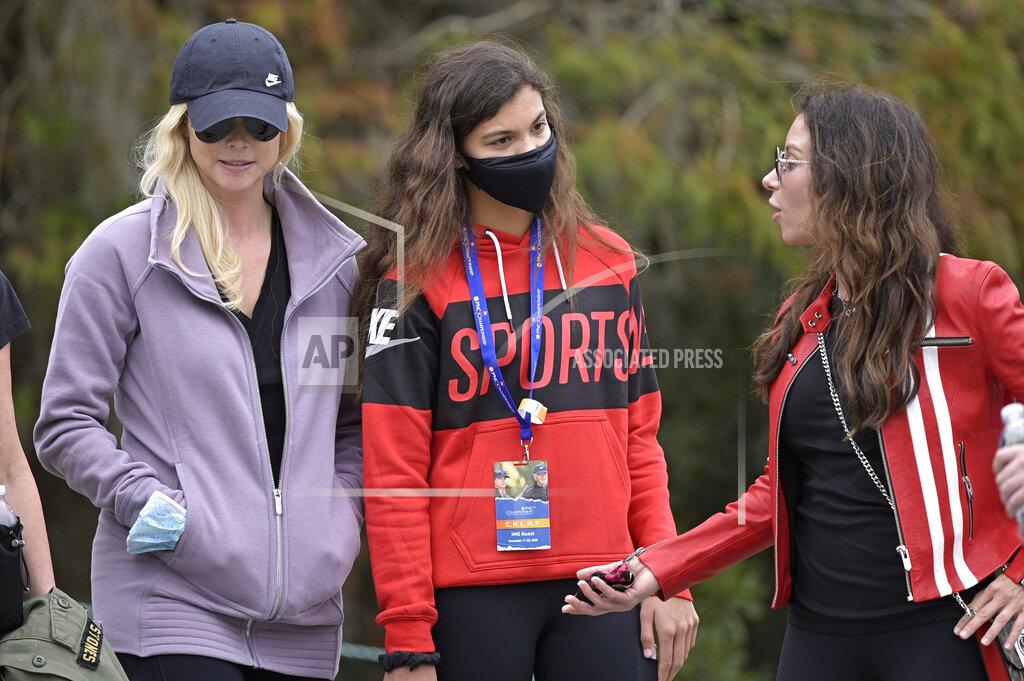 Phelan M. Ebenhack Sam Alexis Woods, center, Elin Nordegren, left, and Erica Herman follow Tiger Woods and Charlie Woods on the 11th hole during the final round of the PNC Championship golf tournament, Sunday, Dec. 20, 2020, in Orlando, Fla. (AP Photo/Phelan M. Ebenhack)