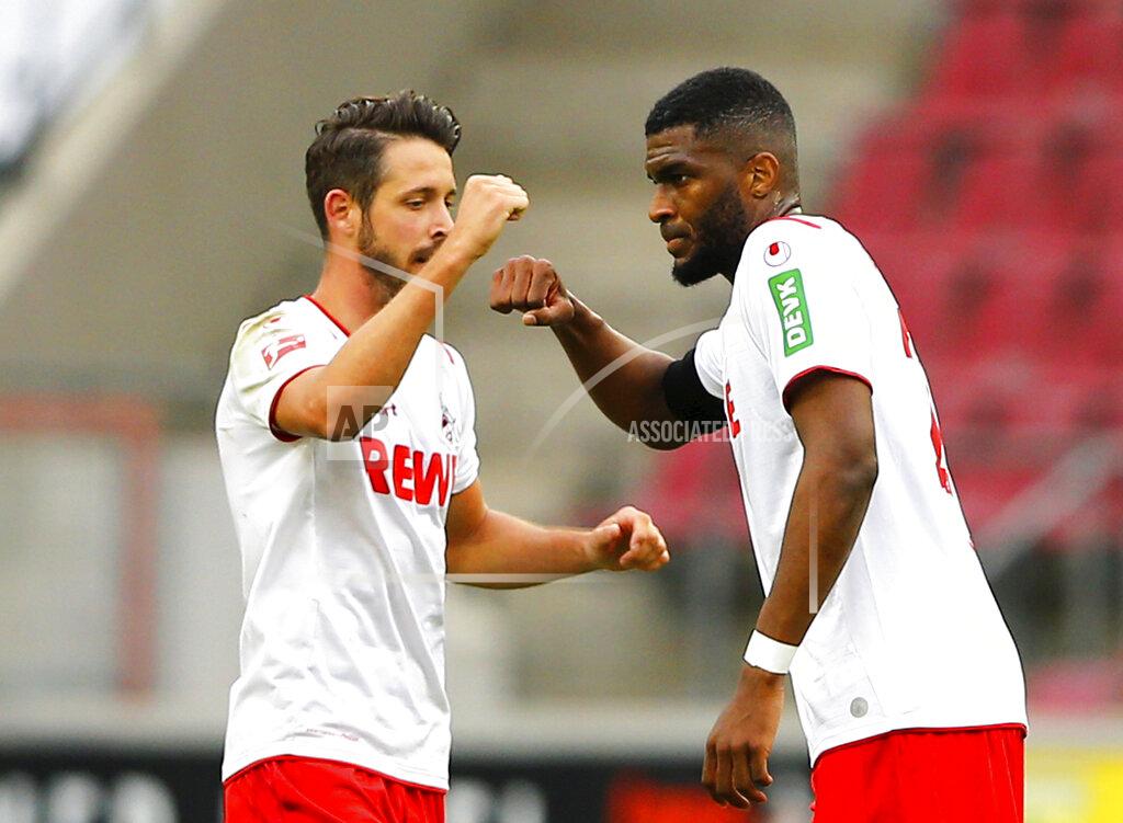 Thilo Schmuelgen FC Cologne's Anthony Modeste, right, celebrates scoring their first goal with Mark Uth during a German Bundesliga soccer match between 1. FC Cologne and Fortuna Duesseldorf in Cologne, Germany, Sunday, May 24, 2020. (Thilo Schmuelgen/pool via AP)
