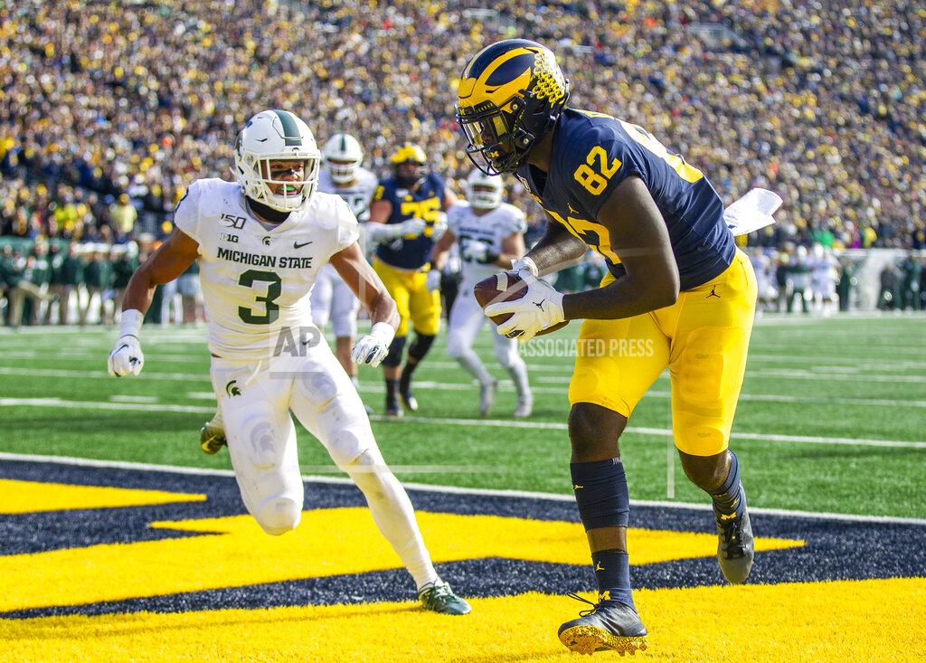 Tony Ding Michigan tight end Nick Eubanks (82) makes a touchdown catch ahead of Michigan State safety Xavier Henderson (3) in the second quarter of an NCAA college football game in Ann Arbor, Mich., Saturday, Nov. 16, 2019. (AP Photo/Tony Ding)