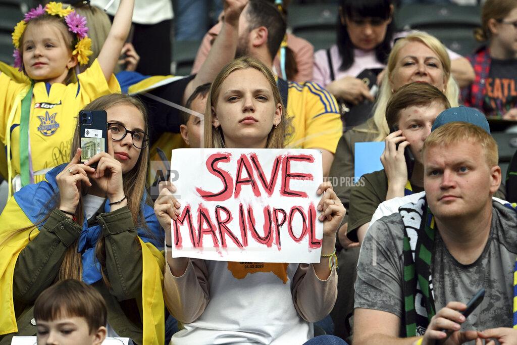 Federico Gambarini A spectator holds up a sign during the soccer match between Borussia Moenchengladbach and Ukraine's national soccer team at Borussia Park, Monchengladbach, Germany, Wednesday May 11, 2022. (Federico Gambarini/dpa via AP)