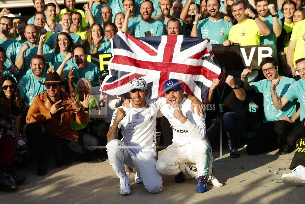 Mercedes driver Lewis Hamilton, left, of Britain, and Mercedes driver Valtteri Bottas, of Finland, celebrate following the Formula One U.S. Grand Prix auto race at the Circuit of the Americas, Sunday, Nov. 3, 2019, in Austin, Texas. (AP Photo/Eric Gay)