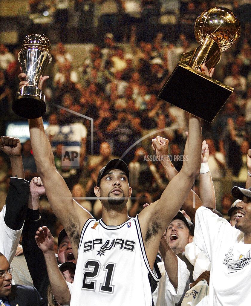 Eric Gay FILE - In this June 23, 2005, file photo, San Antonio Spurs' Tim Duncan (21) holds his MVP trophy, left, and the NBA basketball Championship trophy, right, after San Antonio vbeat the Detroit Pistons 81-74 to win Game 7 of the NBA finals in San Antonio. Kobe Bryant, Tim Duncan and Kevin Garnett are all expected to be officially announced as members of the 2020 enshrinement class for the Basketball Hall of Fame on Saturday, April 4, 2020.(AP Photo/Eric Gay, File)