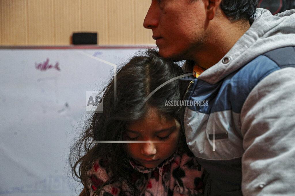 Esteban Felix Jose Collantes holds his five-year-old daughter Kehity before leaving for the government office to request information about the treatment his late wife Silvia Cano received while hospitalized for COVID-19, and present a complaint, two months after she died in Santiago, Chile, Monday, Aug. 3, 2020. The father and daughter are of the thousands of people who have lost loved ones to COVID-19 in Chile, one of the countries in Latin America hardest hit by the virus. (AP Photo/Esteban Felix)