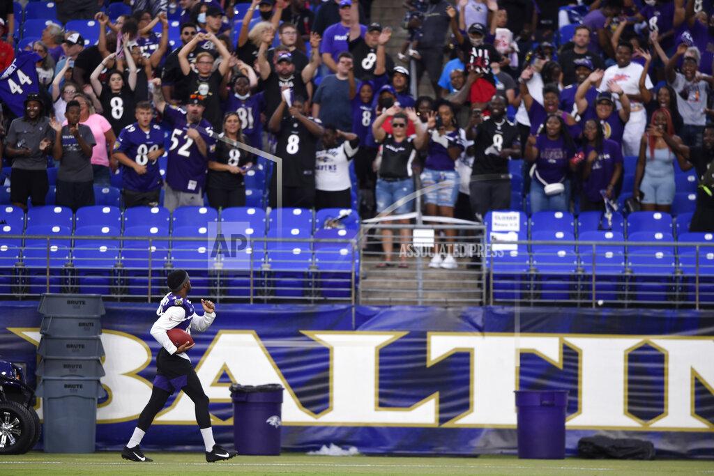 Baltimore Ravens' Marlon Humphreys looks to fans before throwing an autographed football, after practice at NFL football training camp Saturday, July 31, 2021, in Baltimore. (AP Photo/Gail Burton)