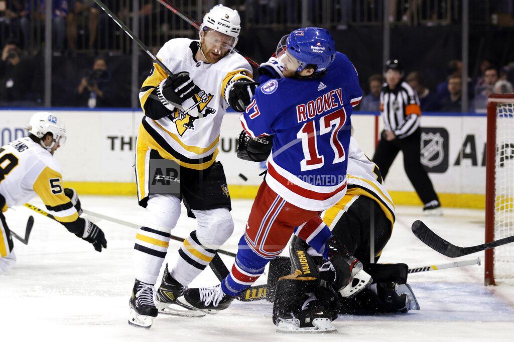 Adam Hunger Pittsburgh Penguins defenseman Mike Matheson pushes New York Rangers center Kevin Rooney (17) to the ice during the second period in Game 7 of an NHL hockey Stanley Cup first-round playoff series, Sunday, May 15, 2022, in New York. (AP Photo/Adam Hunger)