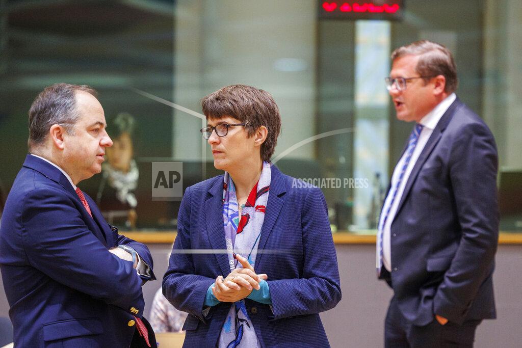 Olivier Matthys Poland's Minister for European Affairs Konrad Szymanski, left, speaks with Germany's Minister of State for Europe and Climate Anna Luehrmann as his ambassador Andrzej Sados looks on during the EU Ministers' General Affairs Council at the European Council building in Brussels, Monday, May 23, 2022. (AP Photo/Olivier Matthys)