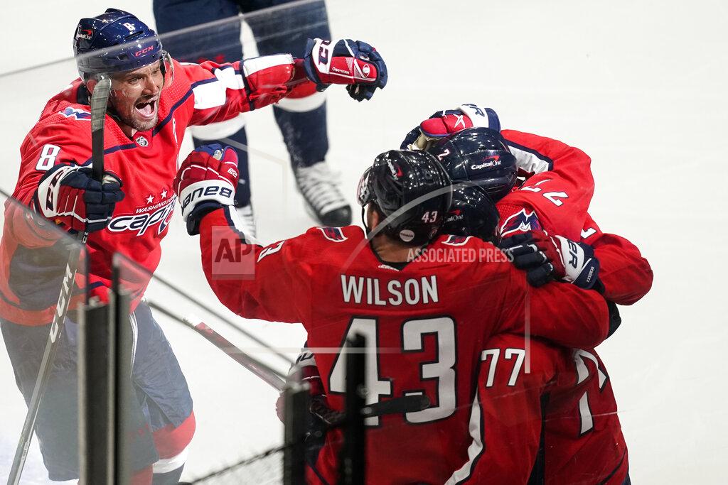 Alex Brandon CORRECTS THAT GOAL WAS SCORED BY NIC DOWD, INSTEAD OF T.J. OSHIE - Washington Capitals left wing Alex Ovechkin (8) comes in to celebrate with right wing Tom Wilson (43), right wing T.J. Oshie (77) and defenseman Justin Schultz (2) after Nic Dowd's overtime goal on a deflection of a shot by Oshie in Game 1 of an NHL hockey Stanley Cup first-round playoff series against the Boston Bruins, Saturday, May 15, 2021, in Washington. The Capitals won 3-2. (AP Photo/Alex Brandon)