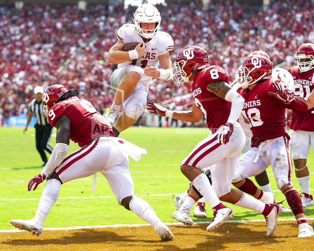 Texas quarterback Sam Ehlinger (11) leaps into the end zone against Texas during an NCAA college football game at the Cotton Bowl, Saturday, Oct. 6, 2018, in Dallas. (Nick Wagner/Austin American-Statesman via AP)