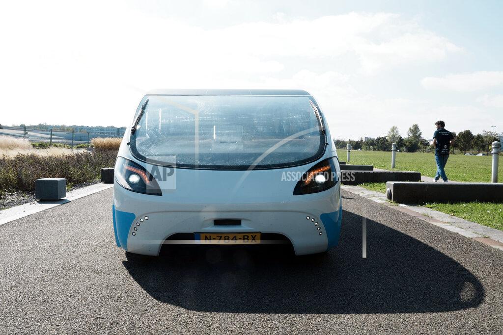 Thibault Camus The solar-powered vehicle is on display on a closed road, in Guyancourt, south of Paris, Friday Sept. 24, 2021. A group of Dutch students has reimagined van life and is hitting the road to Portugal. Just don't call their groundbreaking new solar-powered vehicle a campervan. (AP Photo/Thibault Camus)